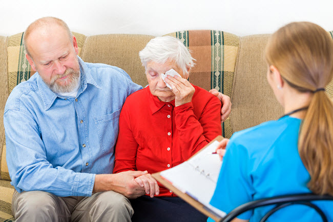 Geriatric Nurse Consulting a Patient.