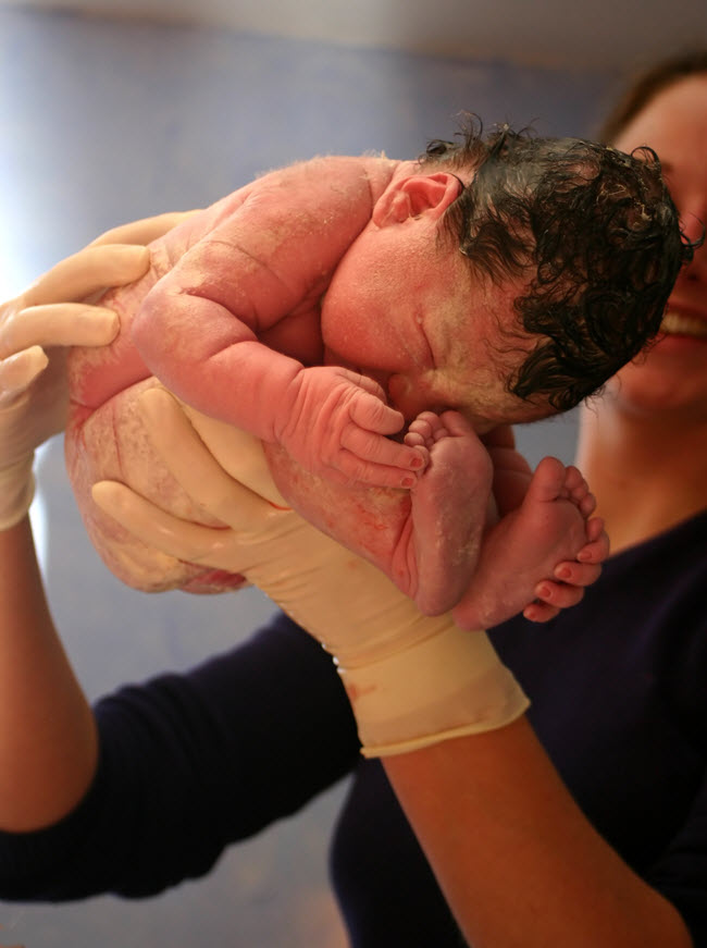 Newborn Boy Held by Midwife.